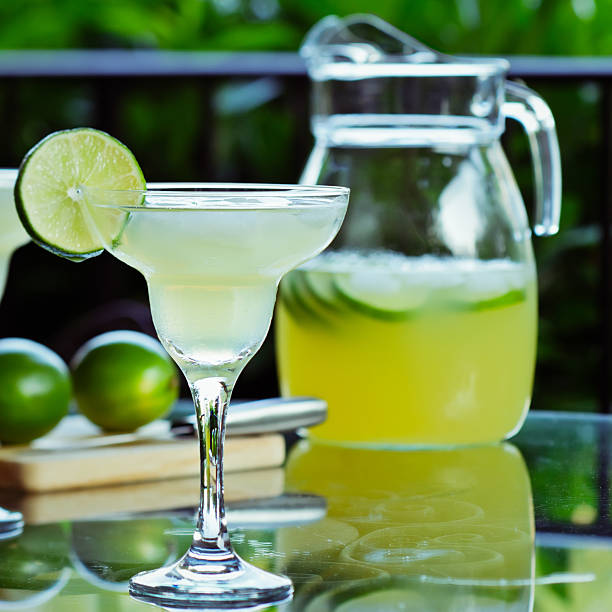 Lime margaritas with glass and pitcher stock photo