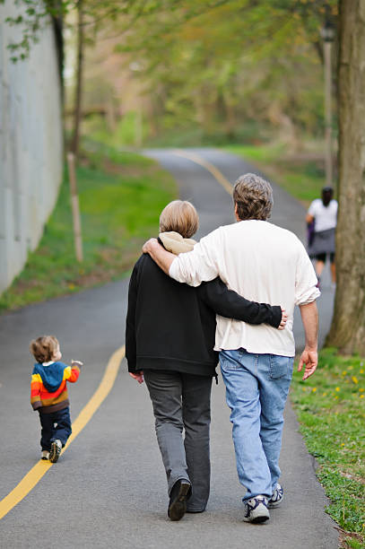 istock Toddler Walking With Grandparents 165175064