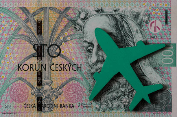 un modelo en miniatura de un avión de pasajeros y un billete de 100 coronas checas - czech culture currency wealth coin fotografías e imágenes de stock