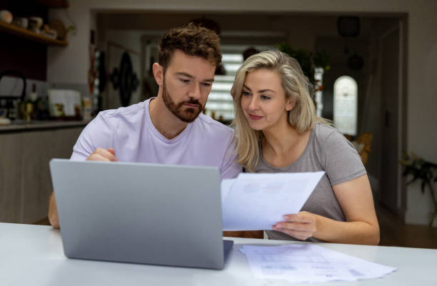 istock Young couple paying bills online at home 1651779232