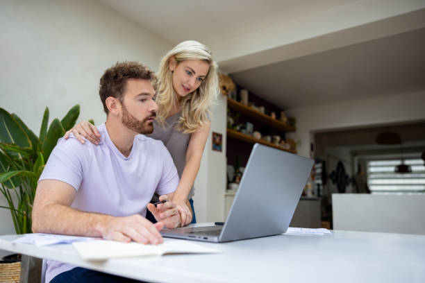 istock Young couple paying bills online while staying at home 1651779777