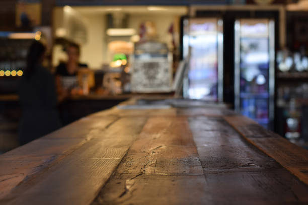 Rustic wooden table at a diner with selective focus and defocused interior for product placement with copy space