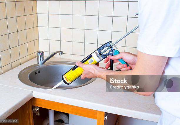 Caulking Gun Putting Silicone Sealant To Installing A Kitchen Sink Stock Photo - Download Image Now