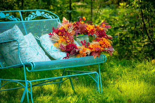 cozy sofa in the garden and autumn decor