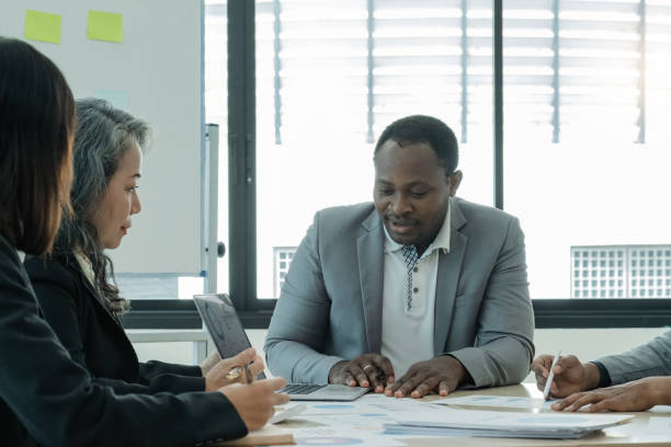 istock Diverse, different nationalities business team discuss work, meeting and strategy in planning, team discussion at office. Collaboration or discussing project plan in conference at workplace 1651876405