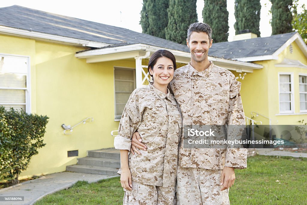 Military Couple In Uniform Standing Outside House Military Couple In Uniform Standing Outside House Smiling To Camera 30-39 Years Stock Photo