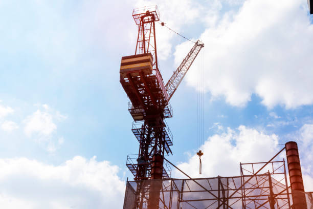 There are high-rise buildings being built.building construction, scaffolding, and lifting building supplies with a construction crane