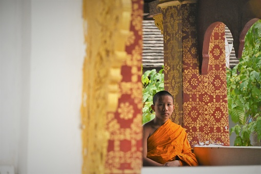 Luang Prabang, Laos - March 21th 2023: Monks in their orange robes are a common sight in the former capital of Laos