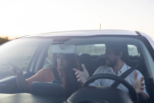 istock Couple talking in a car in traffic 1651933141