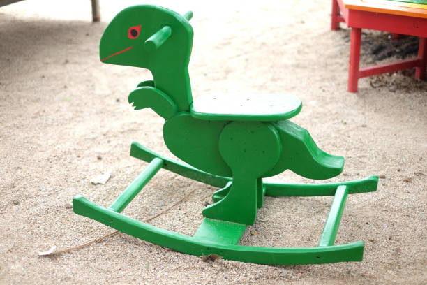 children's green of Dinosaur spring toy in kids playground children's green of Dinosaur spring toy in kids playground playground spring horse stock pictures, royalty-free photos & images