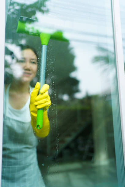istock Housekeeper cleaning window glass. 1652006360