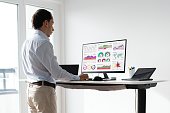 Man Working On Computer At Standing Desk