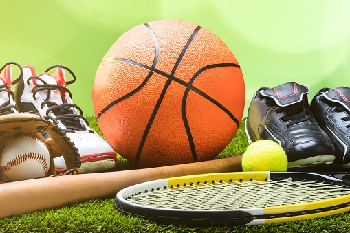 Close-up Of Various Sport Equipments On Pitch Against Bokeh Background