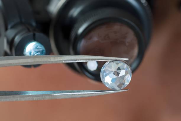 Person Looking At Diamond With Magnifying Loupe