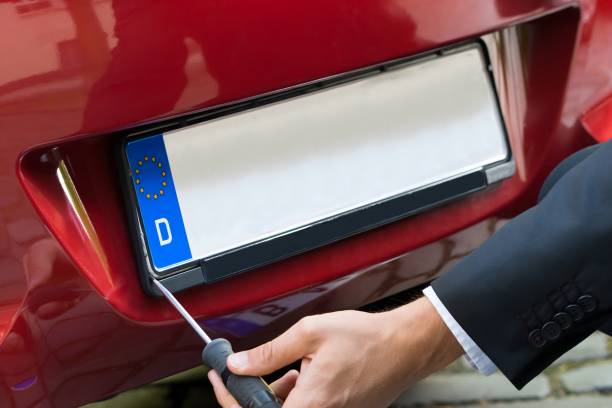 istock Man Changing Car's Number Plate 1652009298