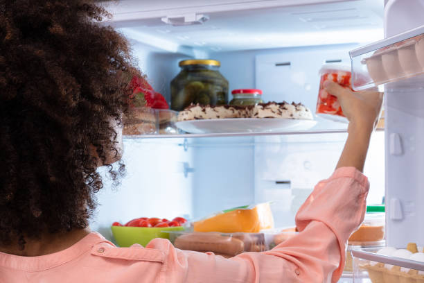 istock Woman Taking Food From Refrigerator 1652009366