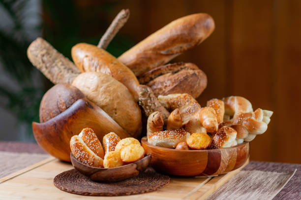 istock Rustic Wooden Bowl Overflowing with Fresh Baked Goods on Table 1652012109