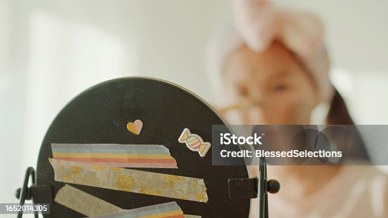 istock Happy mixed Asian preteen girl applying clay facial mask at home, skincare routine, self care and wellness concept 1652014305