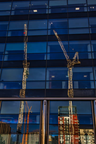 istock Tower cranes constructing new offices in Leeds city reflected in glass windows, Leeds, West Yorkshire, England, Britain 1652014467