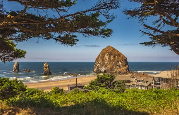 Photo of Cannon Beach Landscape, Oregon USA. Cannon Beach with blue sky in the background on a sunny summer day