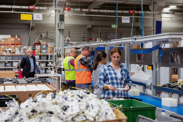 group of workers working on the production line in factory - electric plug electricity women power imagens e fotografias de stock