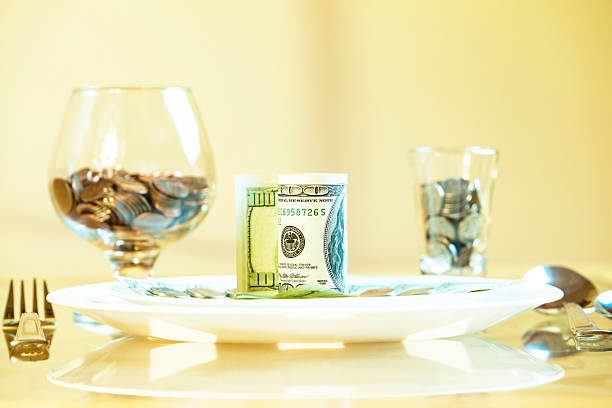 tavolo servito con denaro piatti - soft focus defocused photographic effects tax foto e immagini stock