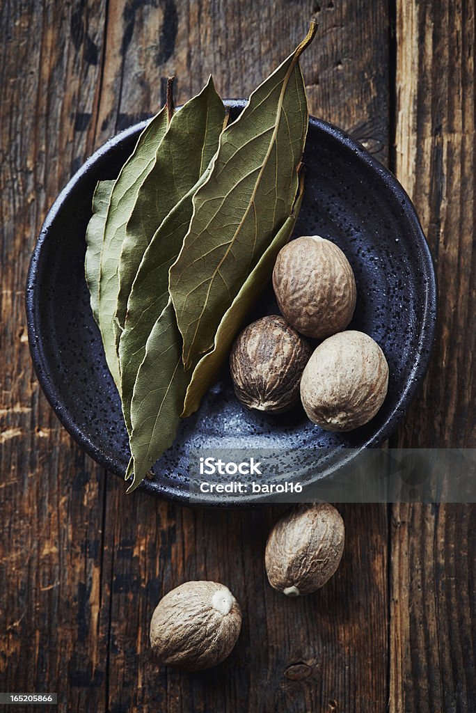 Bay leaves and nutmeg on a small plate Bay Leaf Stock Photo