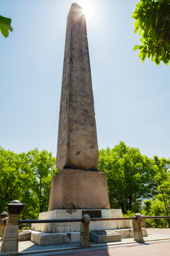 This ancient egyptian obelisk known as Cleopatra's Needle sits in Central Park behind the Metropolitan Museum of Art in New York City. Created in ancient Egypt approximately 3500 years ago, the obelisk was brought to New York City in the late 1800's. Plaques on the base describe the history and provide translations of the Hieroglyphics on the monument.