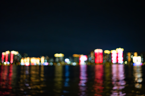 night view of modern city with river at blurred focus as background horizontal composition