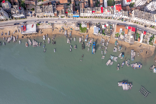 Aerial view of fishing village and fishing port on a sunny day