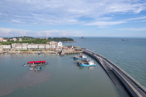 Aerial view of fishing port and traditional fishing village on a sunny day