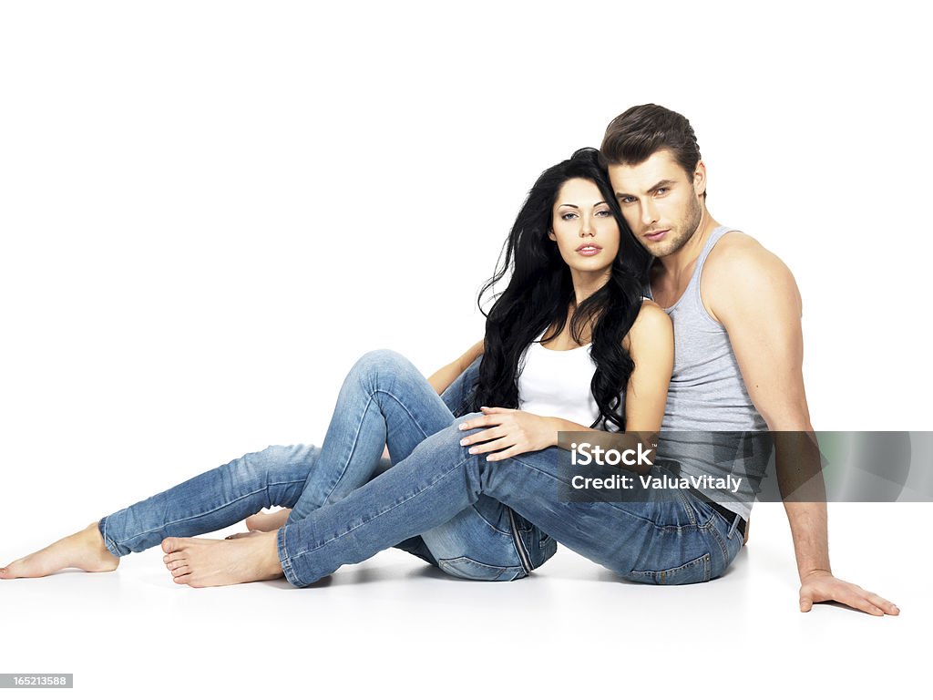 Beautiful sexy couple in love Beautiful sexy couple in love on white background dressed in blue jeanse and white undershirt Couple - Relationship Stock Photo