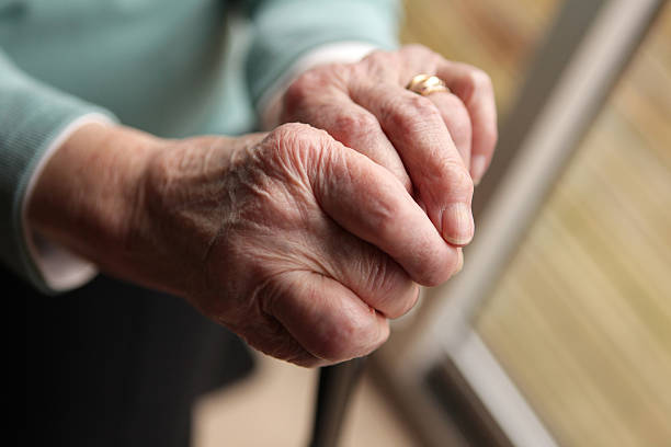 istock Old ladies hands holding a walking stick. 165214930