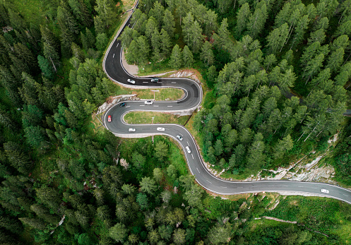 Scenic aerial  view of car on the mountain road in Switzerland in summer