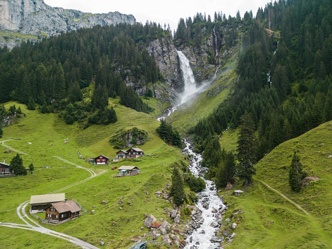 Aerial view of idyllic Stäubifall waterfall and village in Swiss Alps