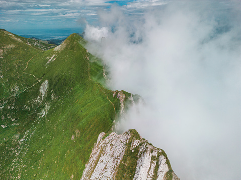 Majestic aerial  view of Swiss Alps  mountain ridge covered in clouds in summer