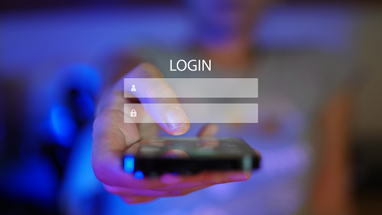 Woman hand showing a mobile phone towards camera viewpoint, digital overlay of login screen