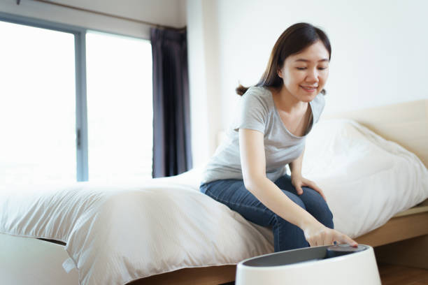 istock Woman using air purifier in bedroom. 1652218875