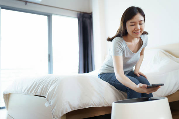 istock Woman using air purifier in bedroom. 1652218886