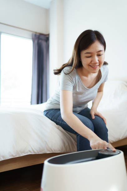 istock Woman using air purifier in bedroom. 1652220960