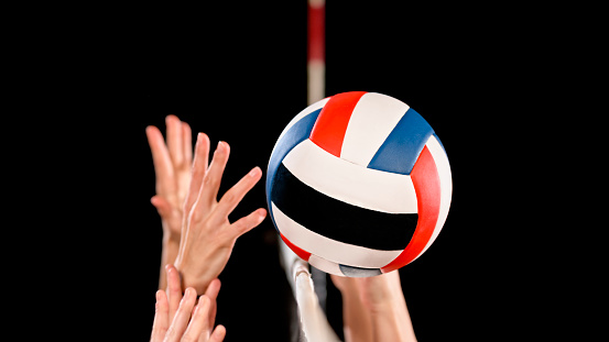 Close-up of hands defending while playing volley ball on court.