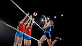 Female volleyball players playing volleyball