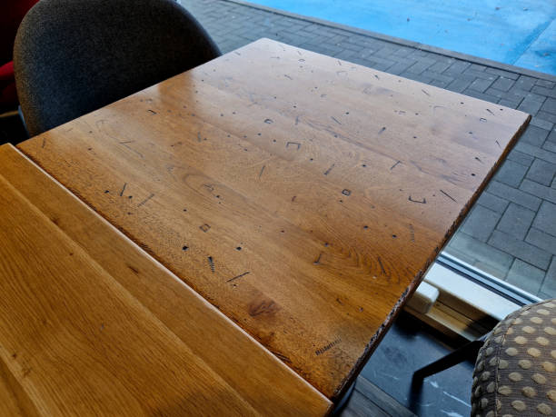 istock table seat with decals stamped into lacquer and accented with black or tan. thread, nut hammer impact marks give impression of wear and history of use 1652229302