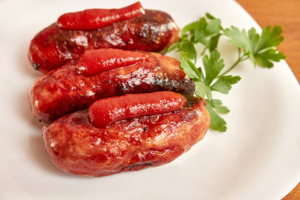 istock Fried sausages with ketchup on a white plate. 1652235362