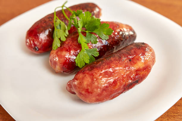 istock Fried sausages with ketchup on a white plate. 1652235938