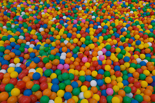 Pool full of colorful balls, red, yellow, green, orange, pink, white, blue, green on playground
