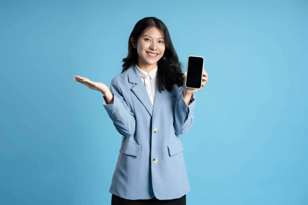 istock image of young businesswoman using phone on blue background 1652296768