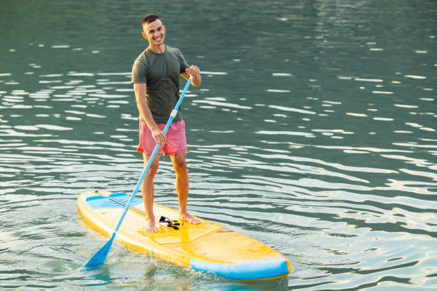 istock Man on sub board floating on ocean sea. 1652305620