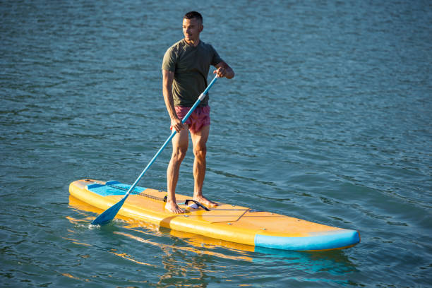 istock Man on sub board floating on ocean sea. 1652306723