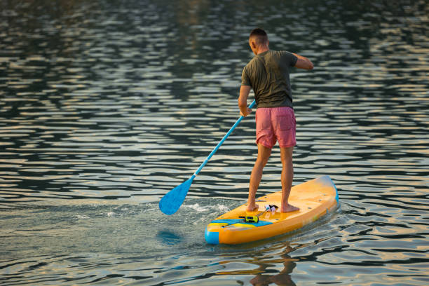 istock Man on sub board floating on ocean sea. 1652307301